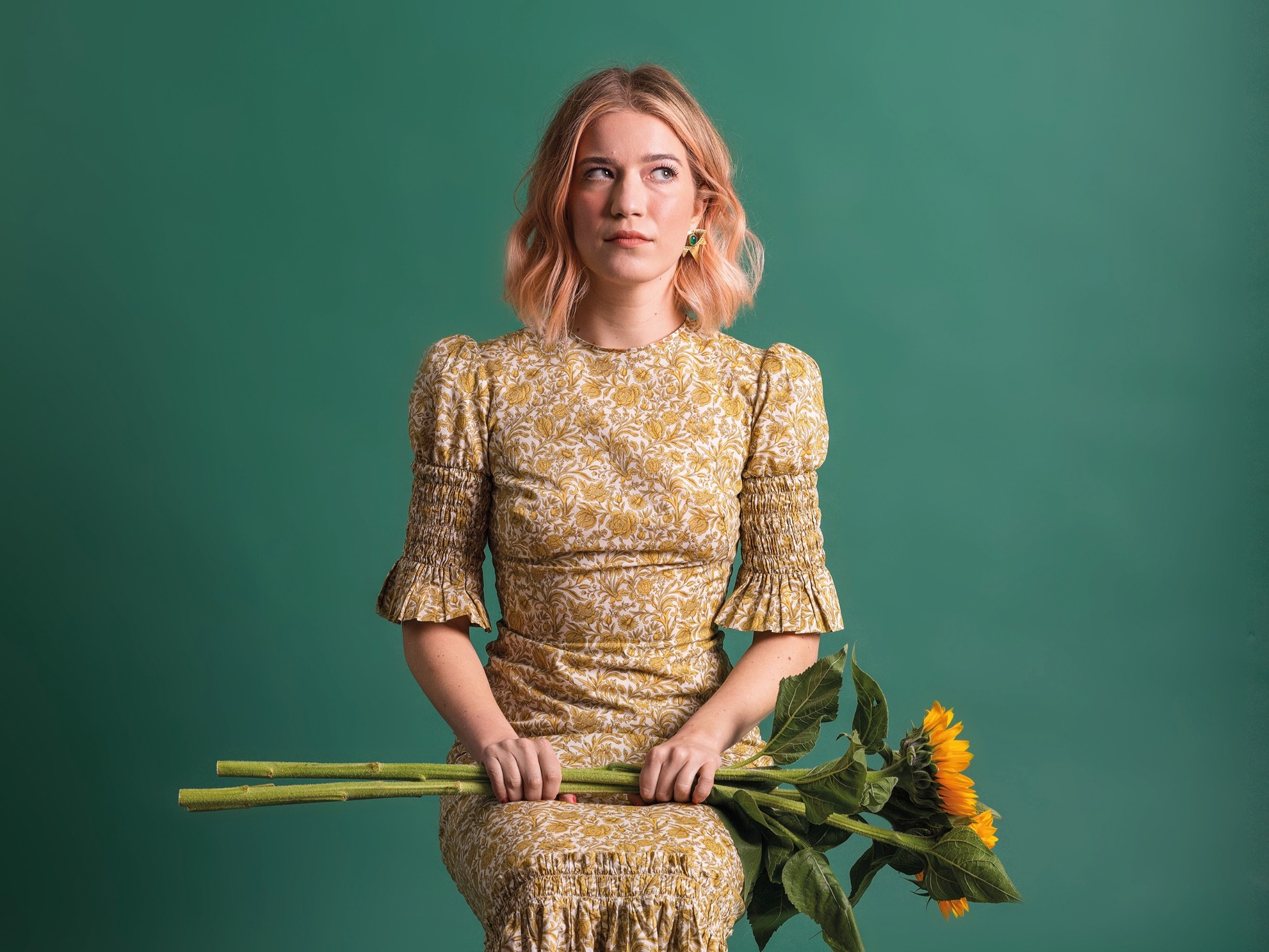 Olga Koch poses with a bunch of sunflowers