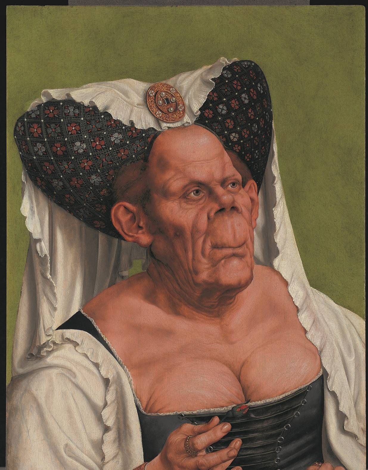 'An Old Woman' - commonly known as 'The Ugly Duchess' - by Quinten Massys. The portrait depicts an old woman with exaggerated features, including a bulging forehead and bosom squeezed into an ill-fitting corset
