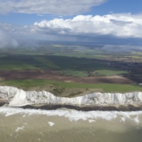 View of green fields from the top of a mountain