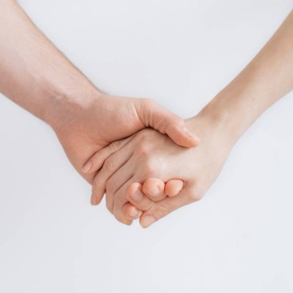 Two people holding hands