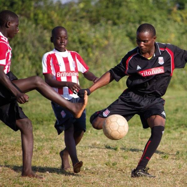 Students play football at a humanist school in Uganda