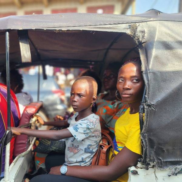 A boy and his mother travel in an auto-rickshaw in Freetown, Sierra Leone