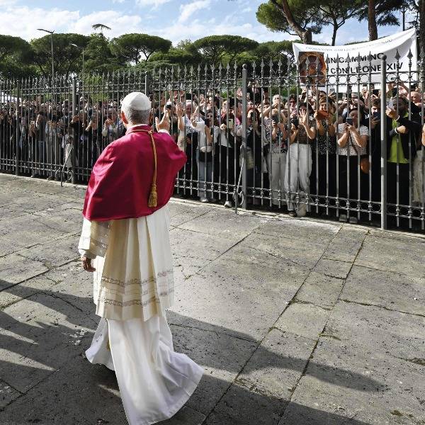 Pope Leo XIV waves to a crowd in Rome