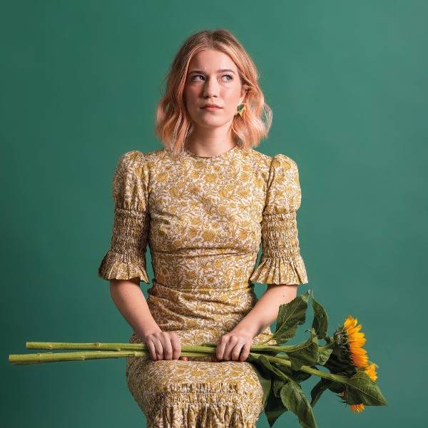 Olga Koch poses with a bunch of sunflowers