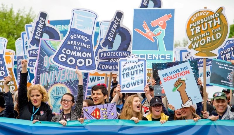 Protesters at the 'March for Science' hold banners with slogans such as 'Science serving the common good'