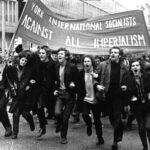 A black and white photo of the author as a young man, taking part in a demonstration of the International Socialists