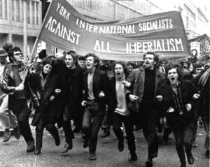 A black and white photo of the author as a young man, taking part in a demonstration of the International Socialists