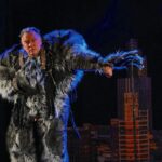 Stewart Lee on stage dressed in a werewolf costume