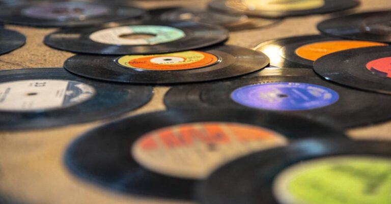 A pile of vinyls on a table