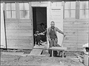 Dorothea Lange, a family settle into their new home, a former horse stall, San Bruno, California