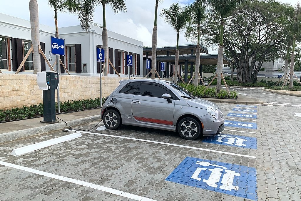 An electric car charging in a car park in Dominican Republic