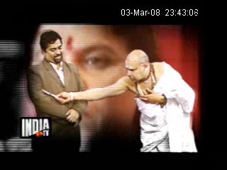 Sanal keeps an eye on the guru as the death challenge commences live on air