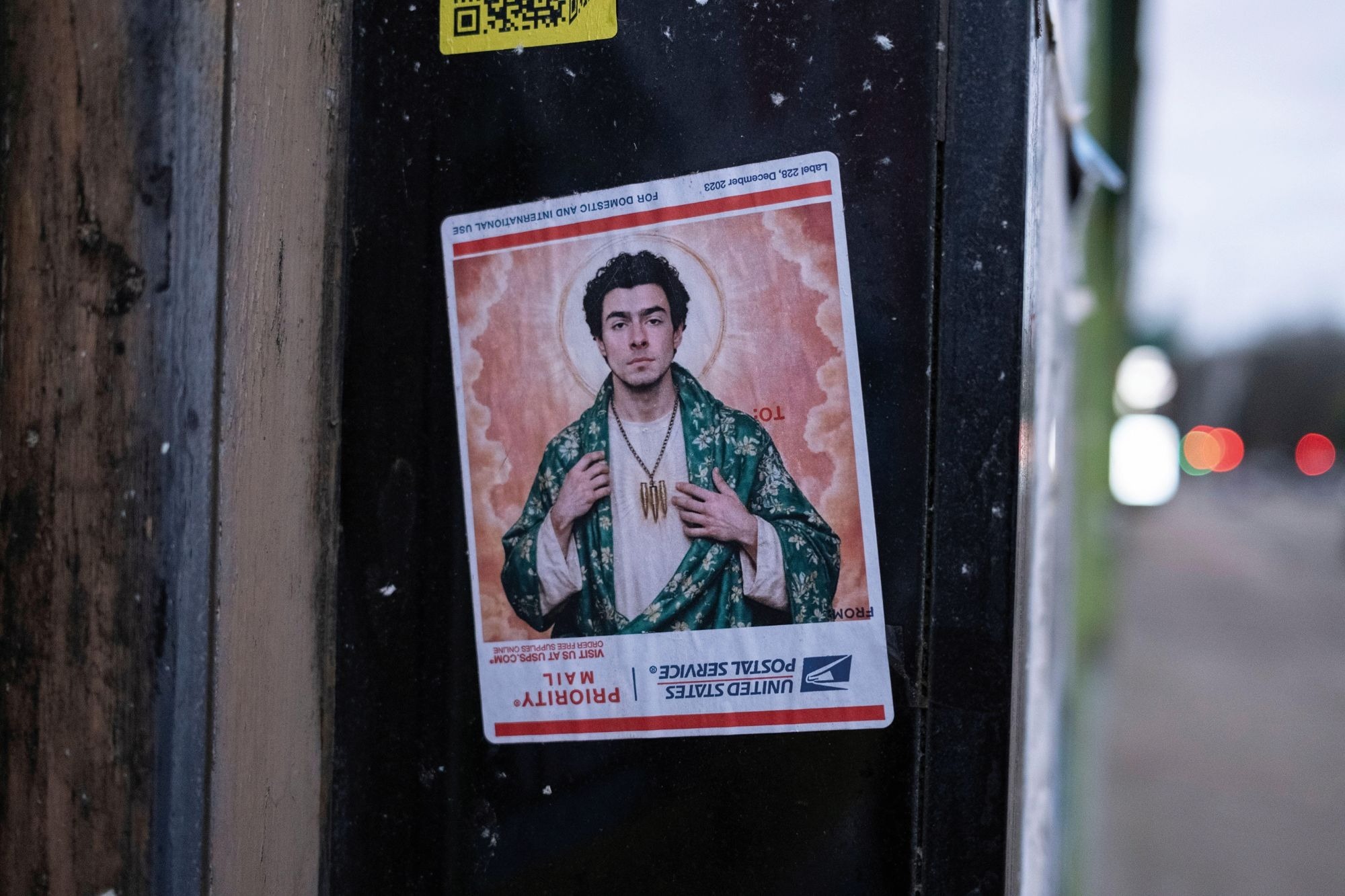 A sticker depicting Luigi Mangione as a religious figure, seen stuck to a building in Glasgow, Scotland