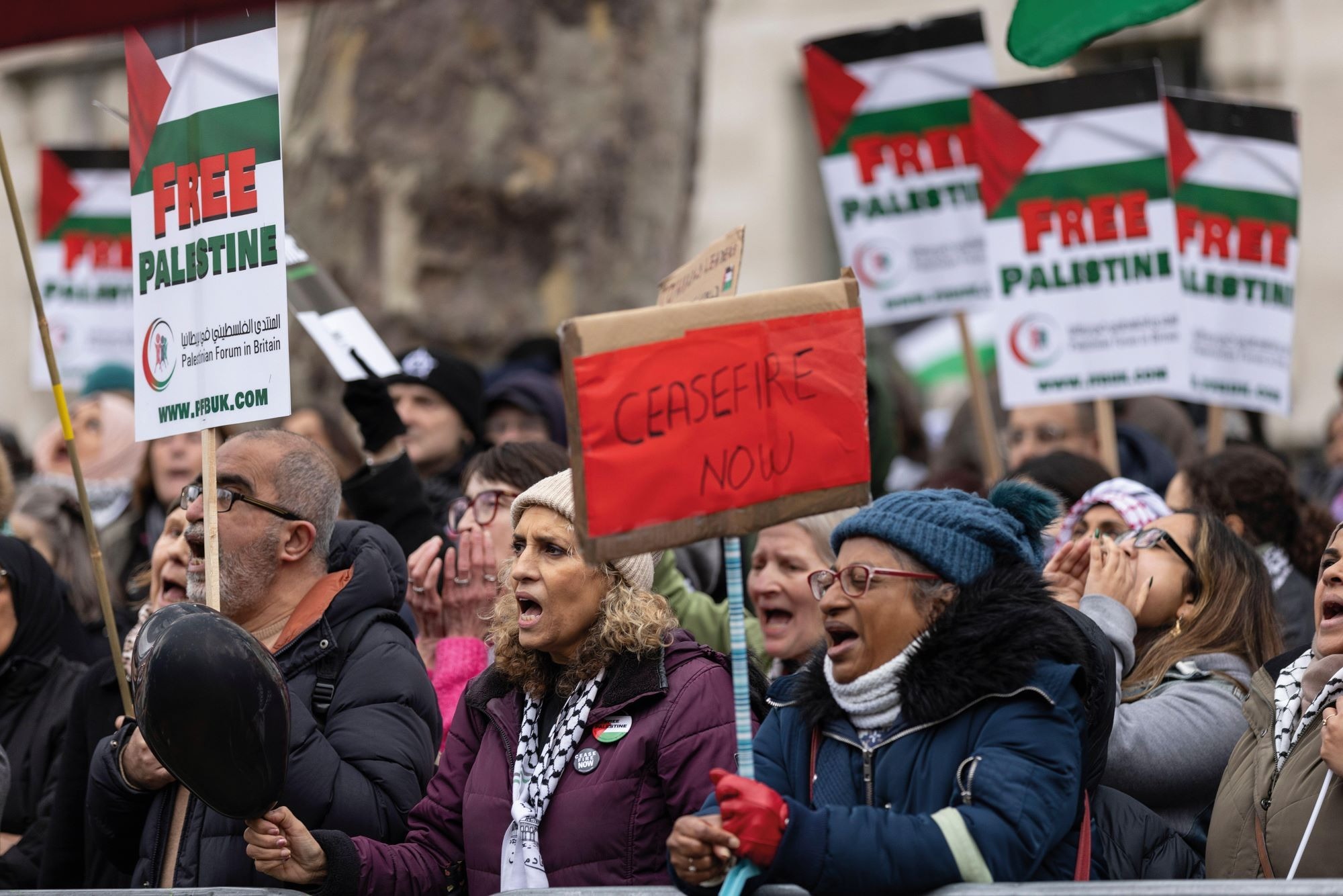 A crowd of people hold placards during a protest for Gaza in London