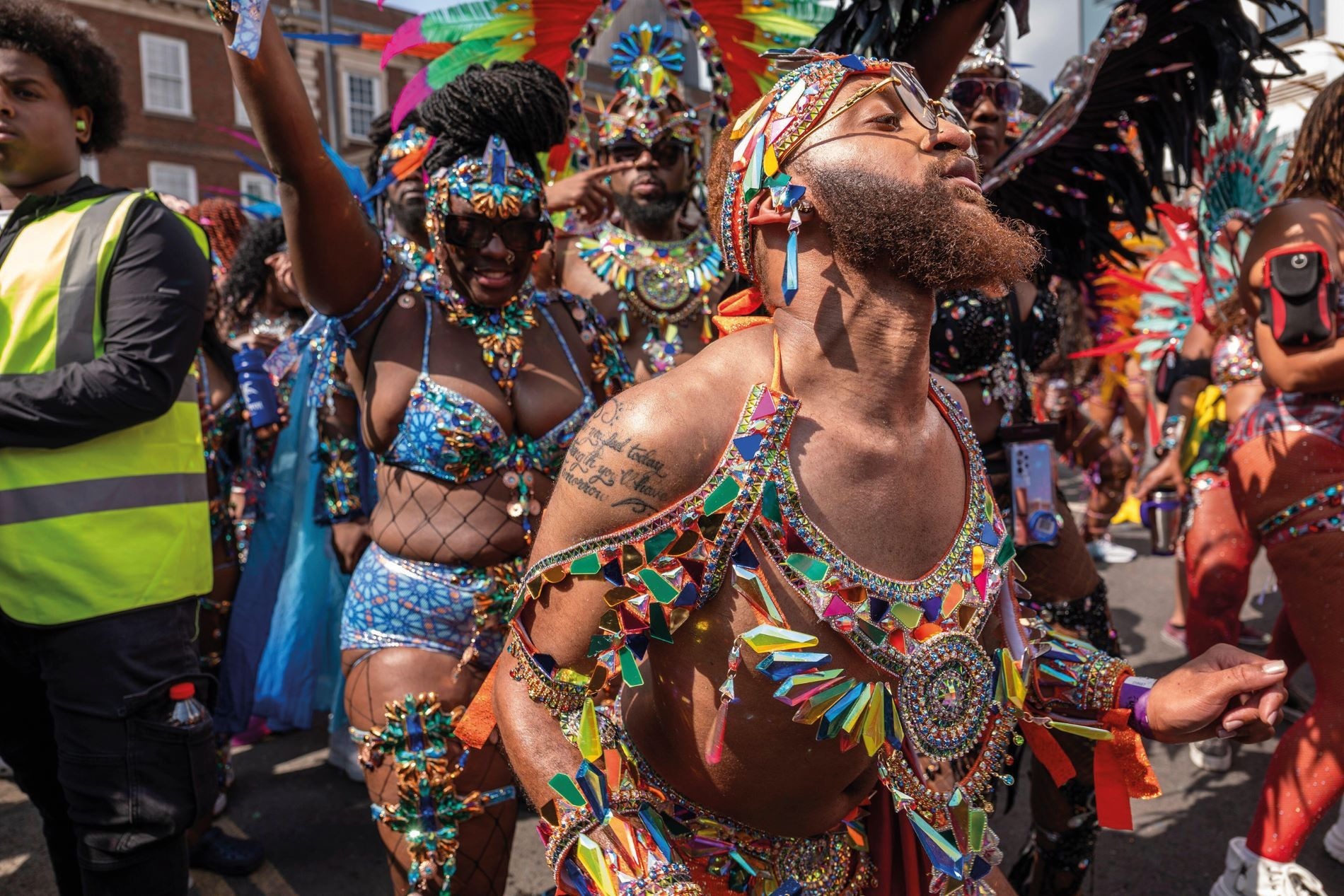 A crowd of revellers in brightly-coloured clothing at the Notting Hill Carnival