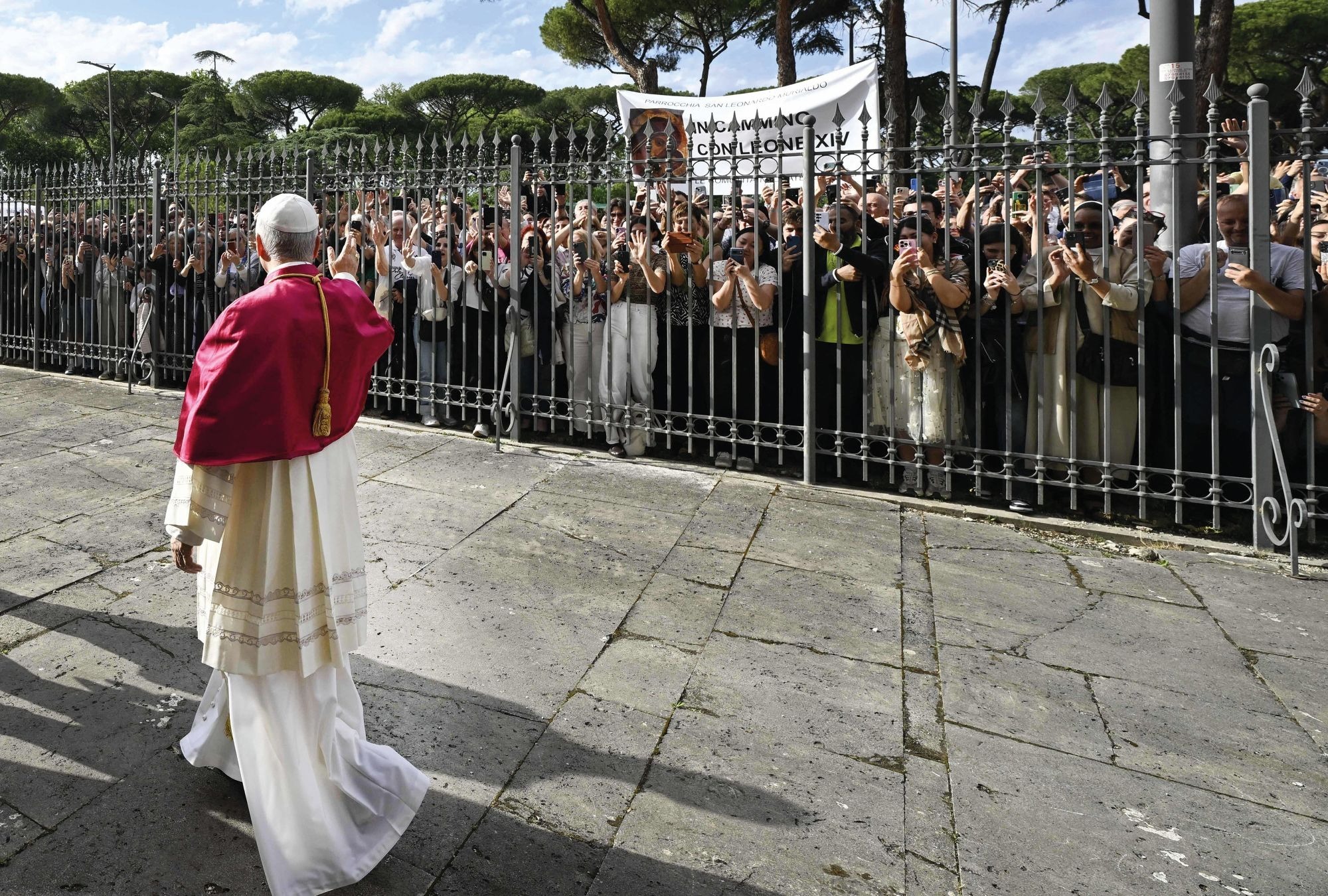 Pope Leo XIV waves to a crowd in Rome