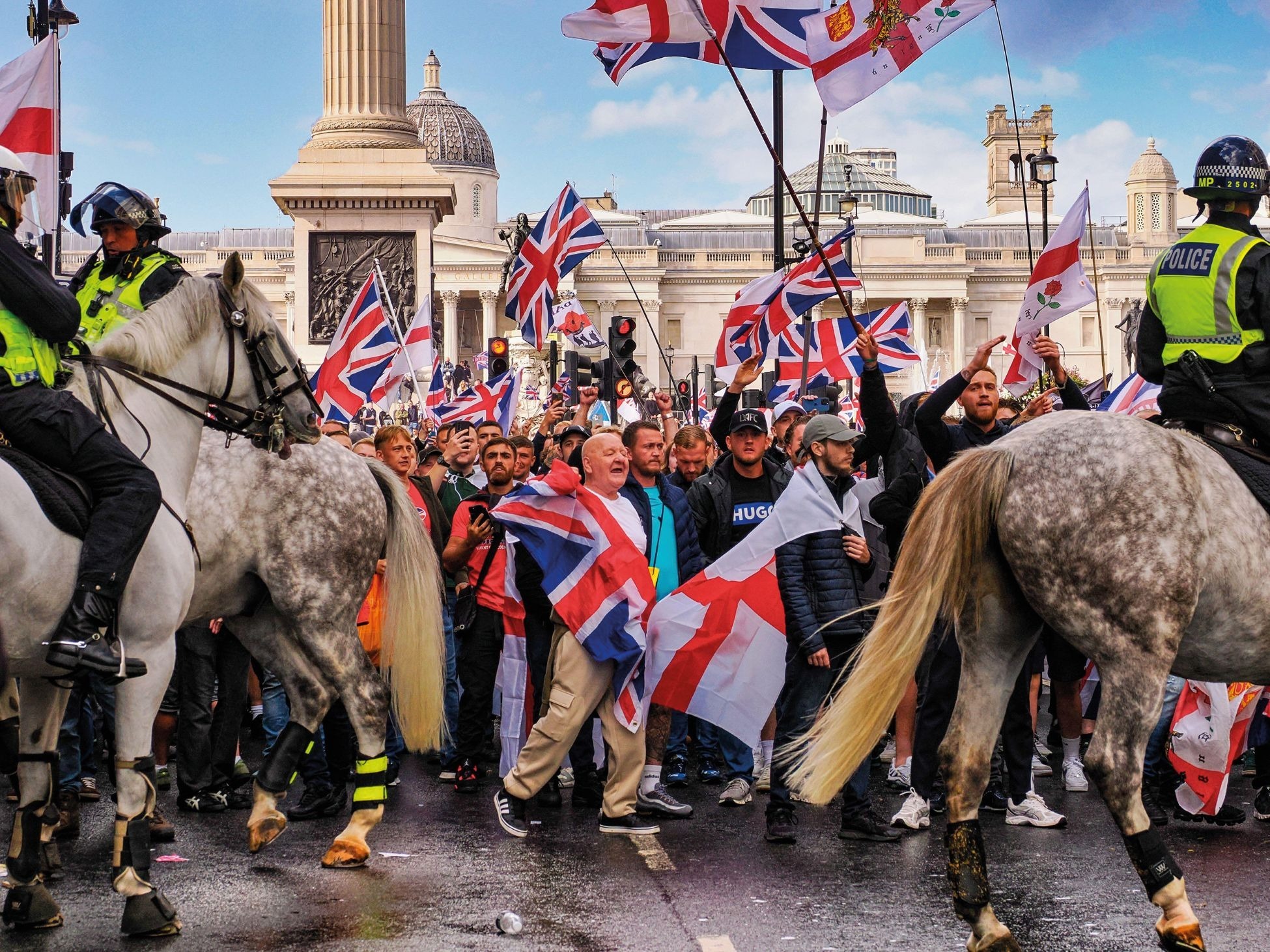 Protesters wave the Union Jack and flag of St George at Tommy Robinson's 'Unite The Kingdom' rally in London, September 2025