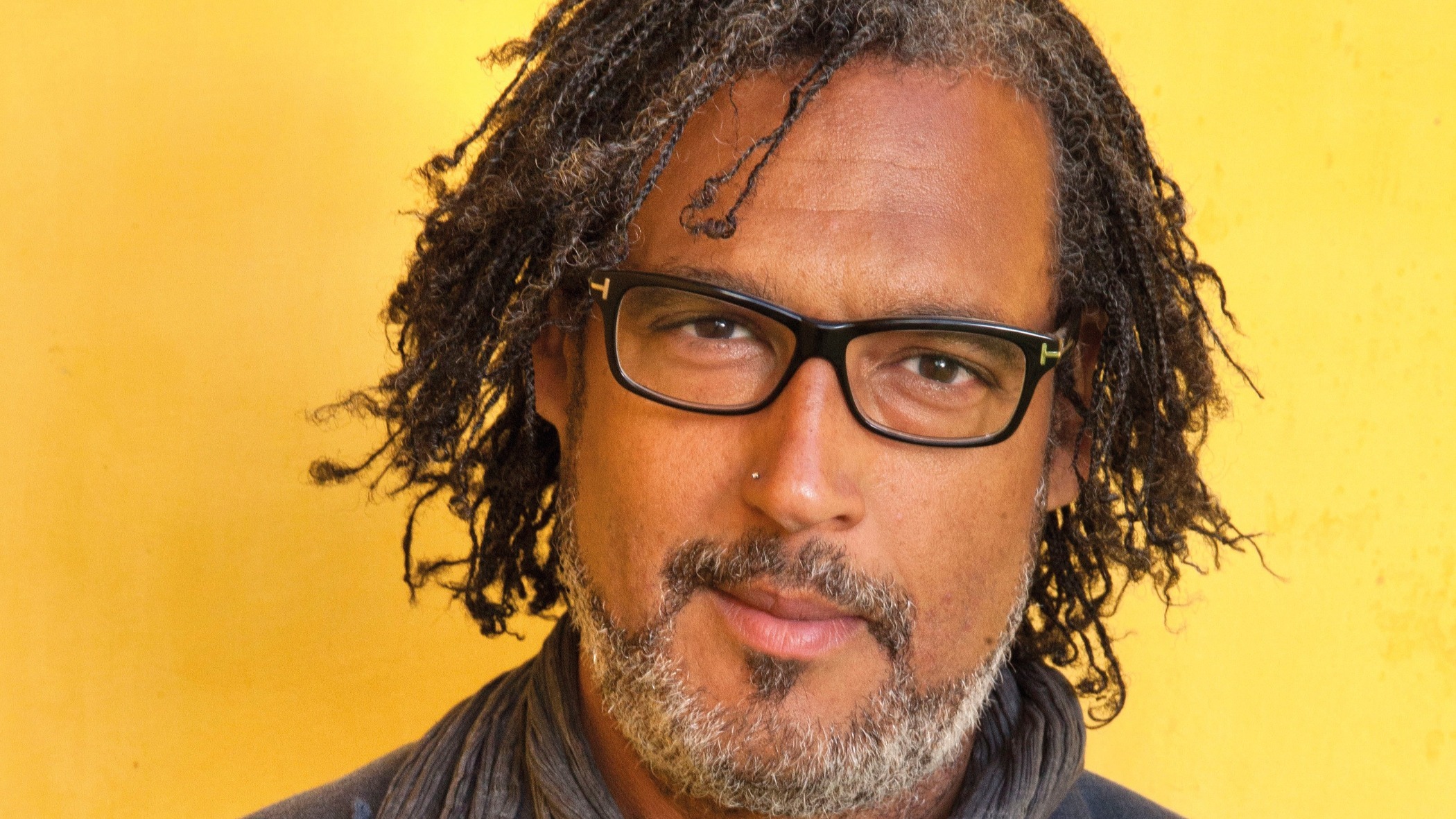 A headshot of David Olusoga