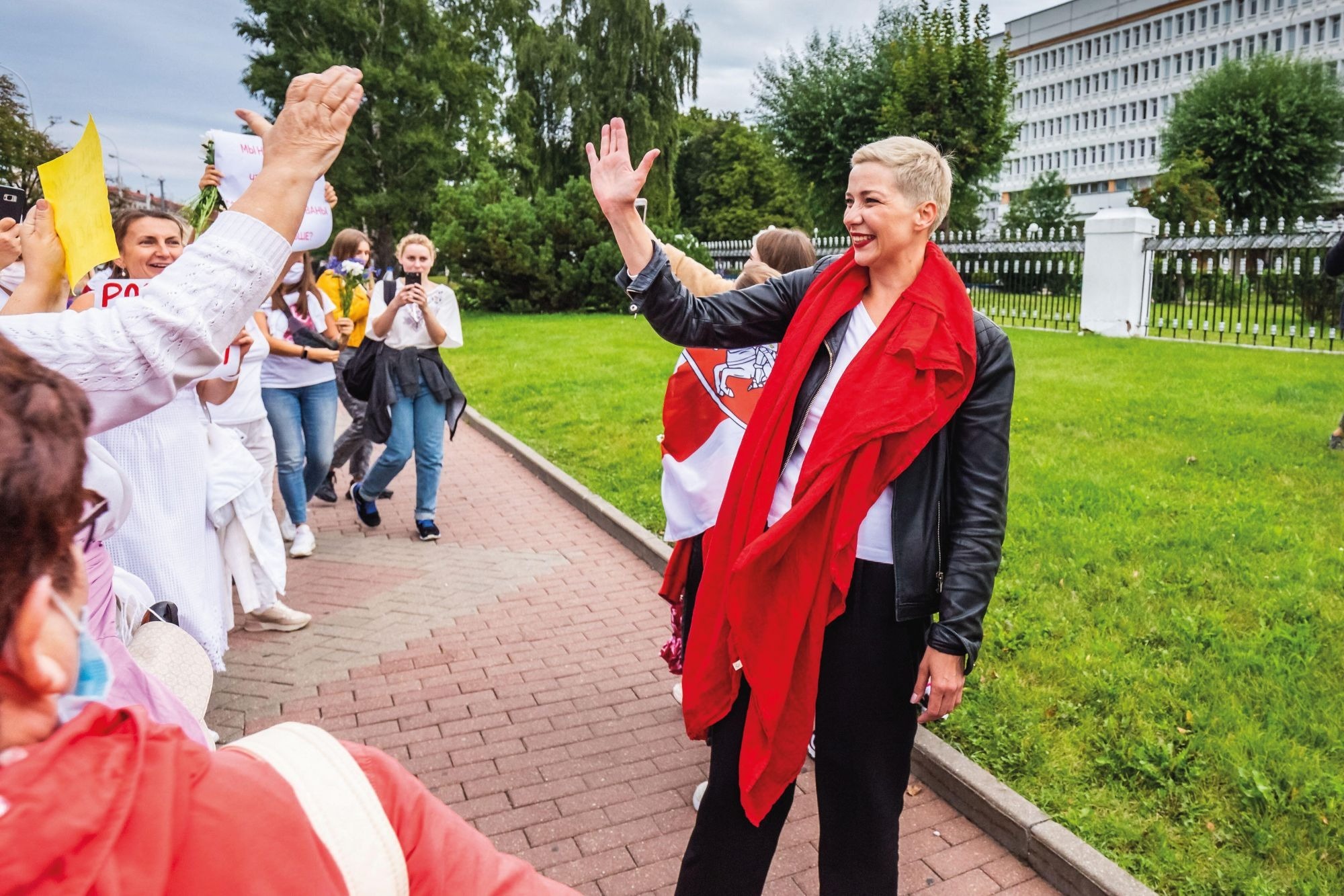 Belarusian political activist Maria Kolesnikova, wearing her signature red lipstick, waves to supporters