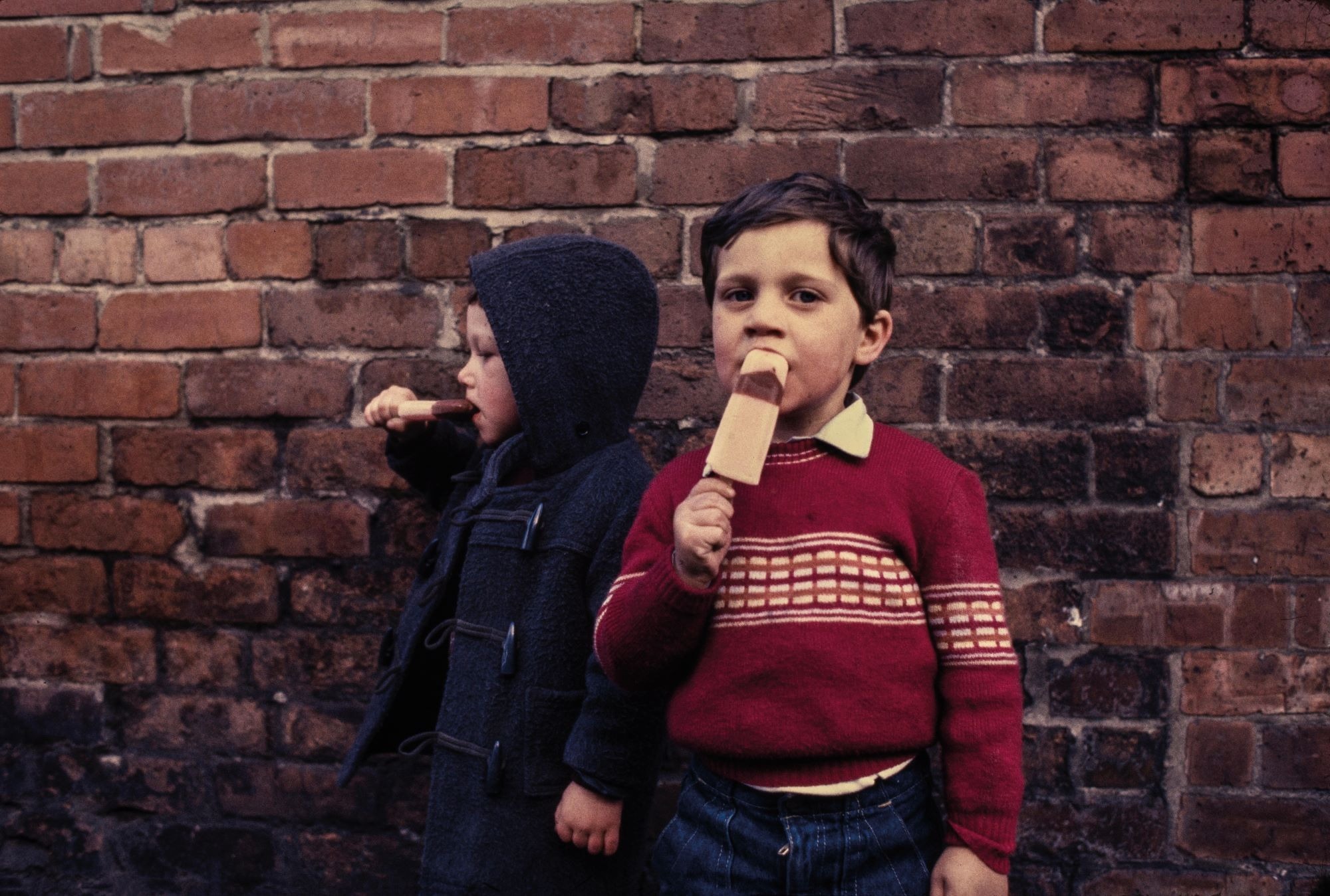 Two young children eating ice creams