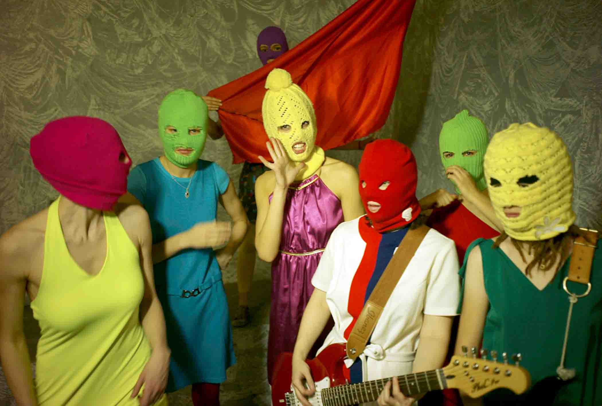 Pussy Riot publicity photo wearing multi-coloured balaclavas