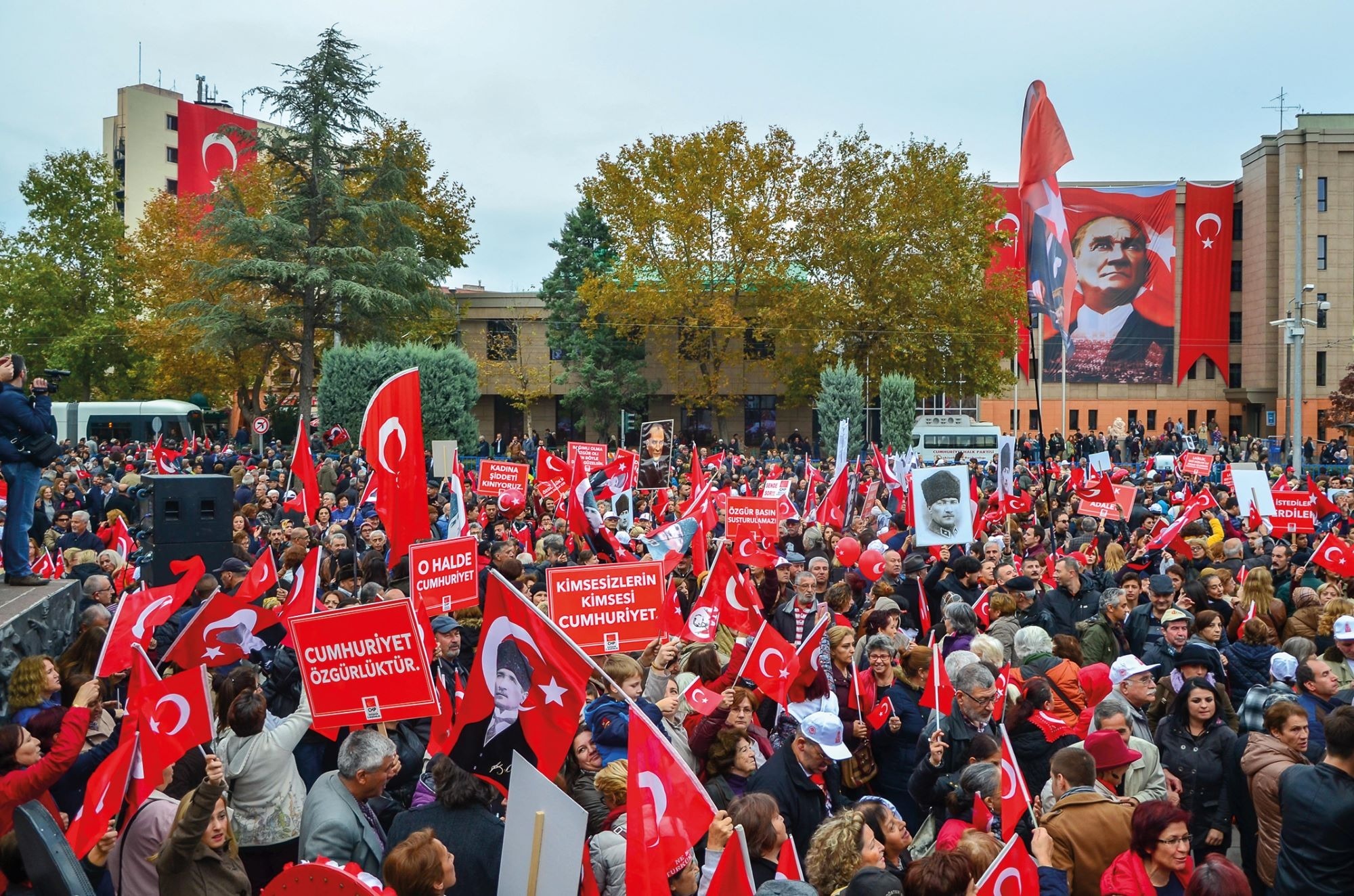 A crowd of people wave flags and banners as they celebrate Republic Day in Turkey